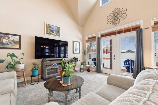 living room with carpet, high vaulted ceiling, and french doors