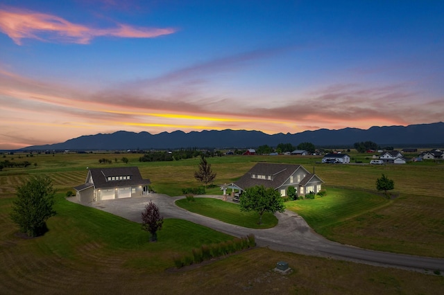 aerial view at dusk featuring a mountain view