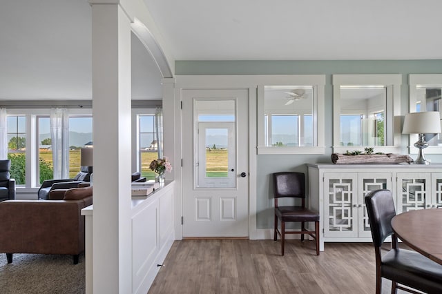 entryway with ceiling fan and light hardwood / wood-style flooring