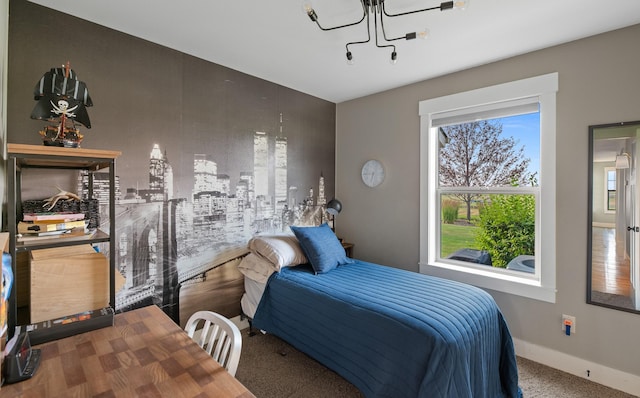 bedroom featuring carpet floors and a chandelier