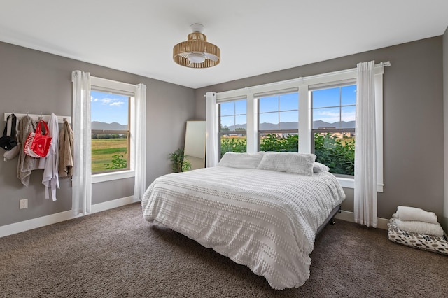 carpeted bedroom with a mountain view