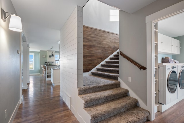 staircase with hardwood / wood-style floors and independent washer and dryer