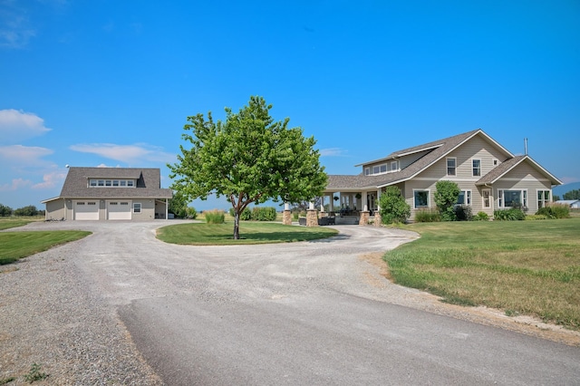 view of front of property featuring a front yard and a garage