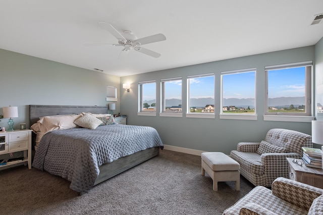 bedroom with ceiling fan, a mountain view, and carpet floors