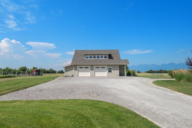 exterior space with a mountain view, a garage, and a front yard