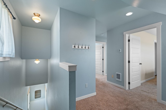 hallway with light colored carpet