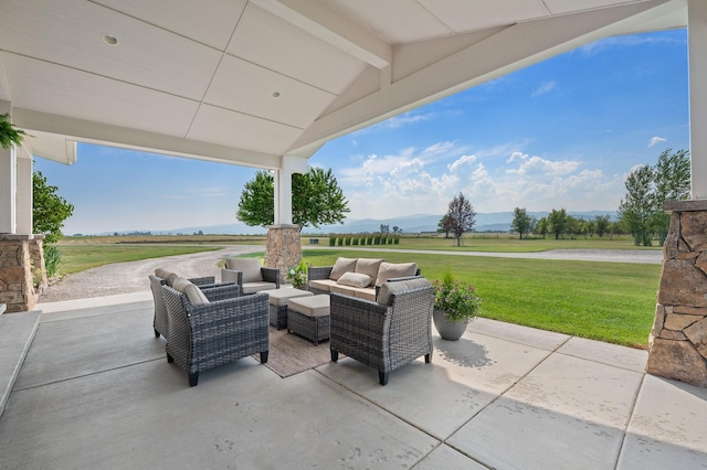 view of patio with outdoor lounge area, a mountain view, and a rural view