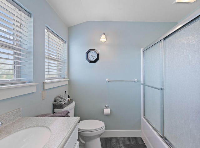 full bathroom featuring vanity, combined bath / shower with glass door, vaulted ceiling, hardwood / wood-style flooring, and toilet