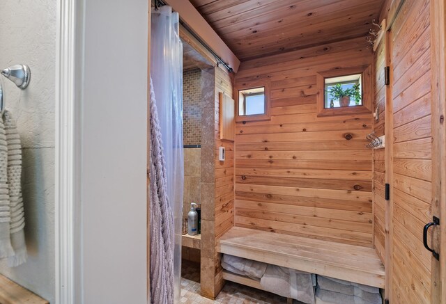 bathroom with wood walls and wood ceiling