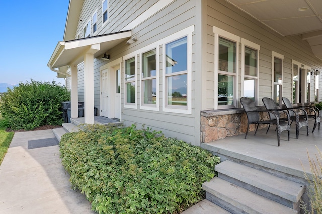 view of side of property with covered porch