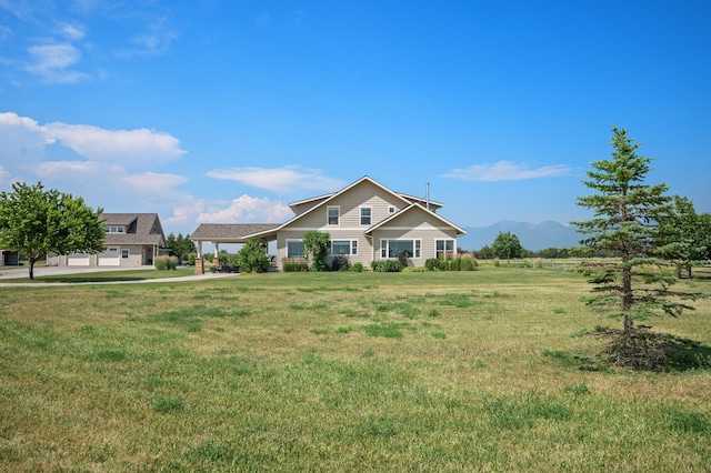 view of front of house with a front yard and a mountain view