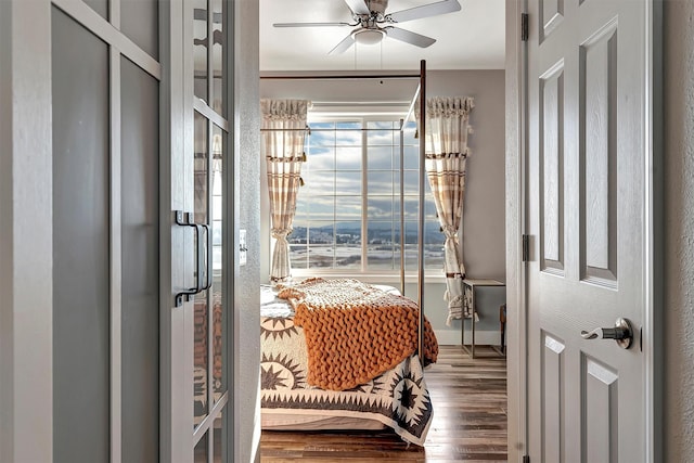 bedroom with wood-type flooring and ceiling fan