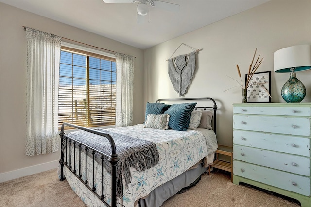 bedroom with ceiling fan and light carpet