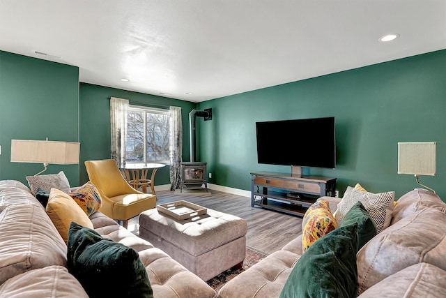 living room featuring hardwood / wood-style flooring and a wood stove