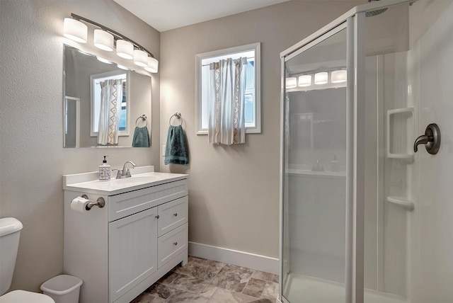 bathroom with vanity, toilet, and walk in shower