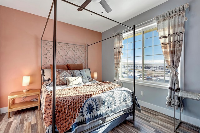 bedroom with ceiling fan and wood-type flooring