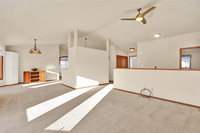 kitchen with kitchen peninsula, white appliances, sink, light hardwood / wood-style flooring, and hanging light fixtures