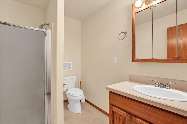 bathroom with vanity, toilet, and a shower with shower door