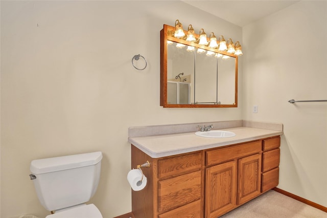 bathroom with vanity, toilet, and walk in shower