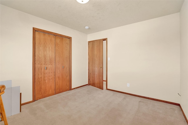 unfurnished bedroom with light carpet and a closet