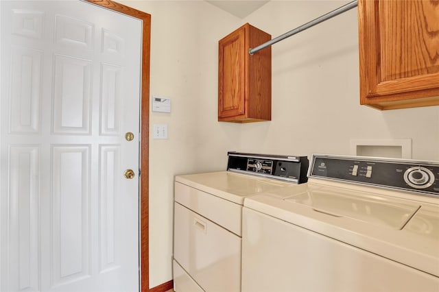 laundry room featuring cabinets and washing machine and dryer