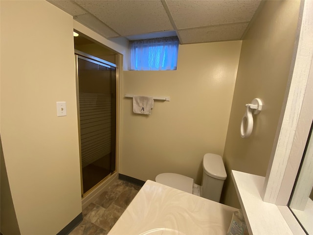 bathroom with vanity, toilet, a paneled ceiling, and walk in shower