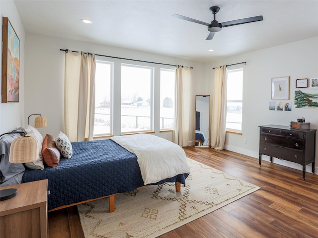 bedroom with ceiling fan and dark wood-type flooring