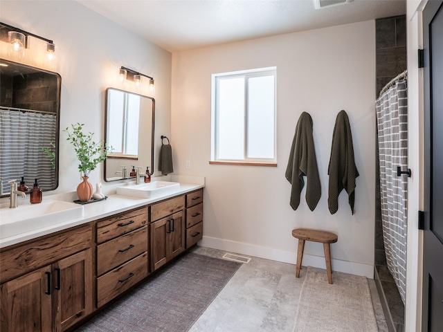 bathroom featuring a wealth of natural light, walk in shower, and vanity