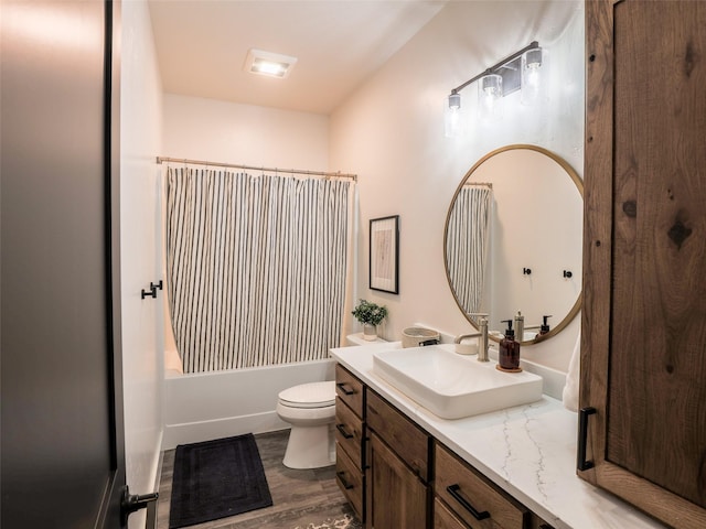 full bathroom featuring toilet, shower / bathtub combination with curtain, hardwood / wood-style flooring, and vanity