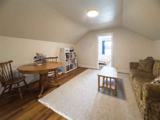 interior space featuring dark wood-type flooring and lofted ceiling