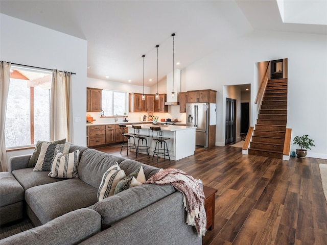 living room featuring high vaulted ceiling, dark hardwood / wood-style flooring, and sink