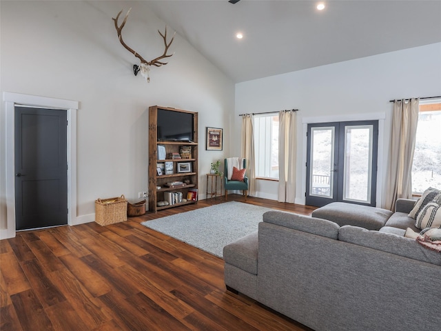 living room with high vaulted ceiling, a healthy amount of sunlight, french doors, and dark hardwood / wood-style floors