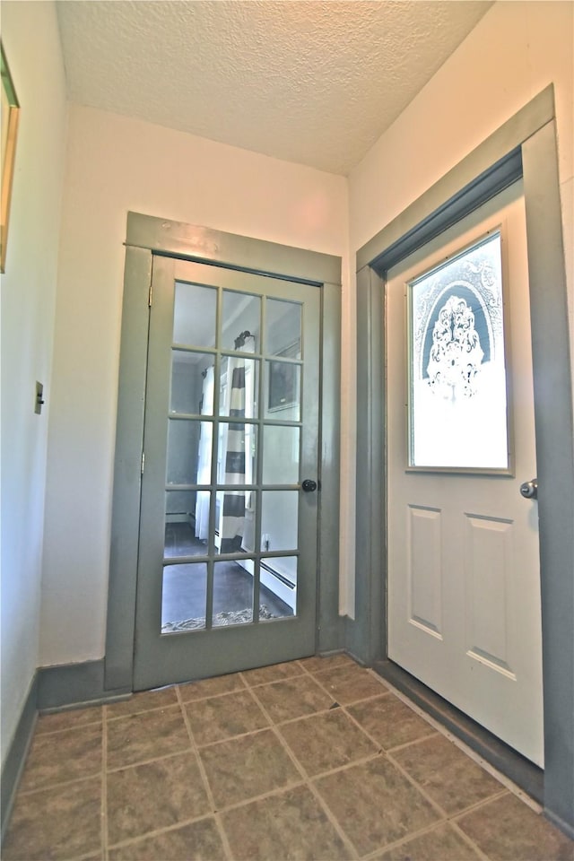 foyer entrance with a textured ceiling