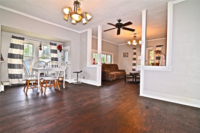 dining space with a wealth of natural light, ceiling fan with notable chandelier, and ornamental molding