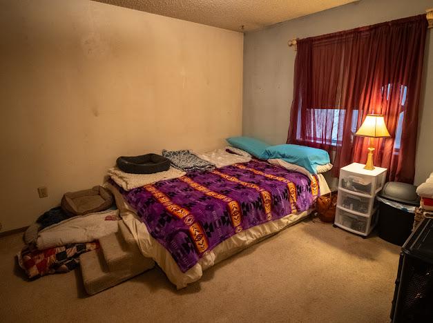 carpeted bedroom with a textured ceiling