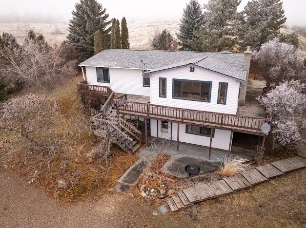 rear view of house featuring a patio and a deck