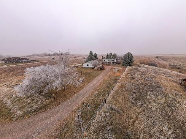 birds eye view of property with a rural view