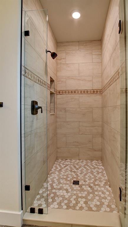 bathroom with a shower with door