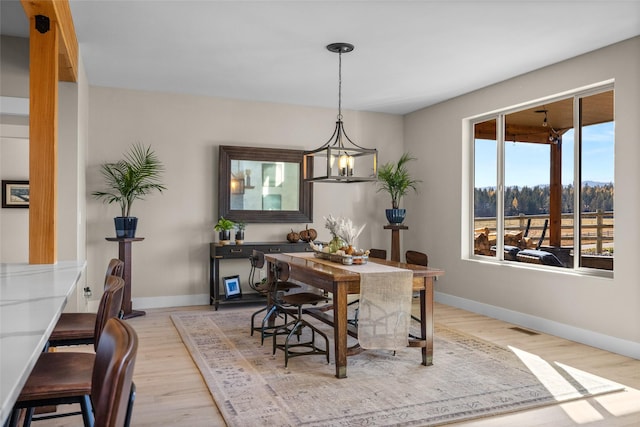 dining area featuring a chandelier and light hardwood / wood-style flooring