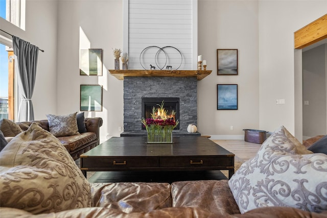 living room featuring a fireplace, light hardwood / wood-style flooring, and plenty of natural light