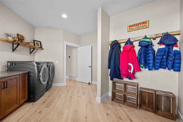 laundry room featuring light wood-type flooring and independent washer and dryer