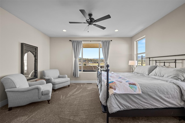 bedroom with multiple windows, ceiling fan, and carpet floors