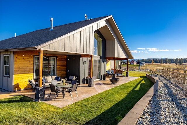 rear view of house featuring a lawn and a patio area