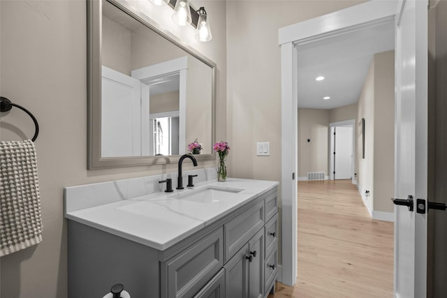 bathroom with vanity and hardwood / wood-style flooring