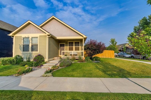 view of front of home with a porch and a front lawn