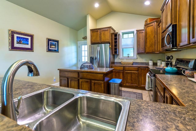 kitchen with light tile patterned floors, sink, appliances with stainless steel finishes, and vaulted ceiling