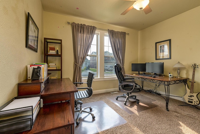 carpeted office space with ceiling fan