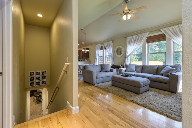 living room with lofted ceiling, ceiling fan, and wood-type flooring