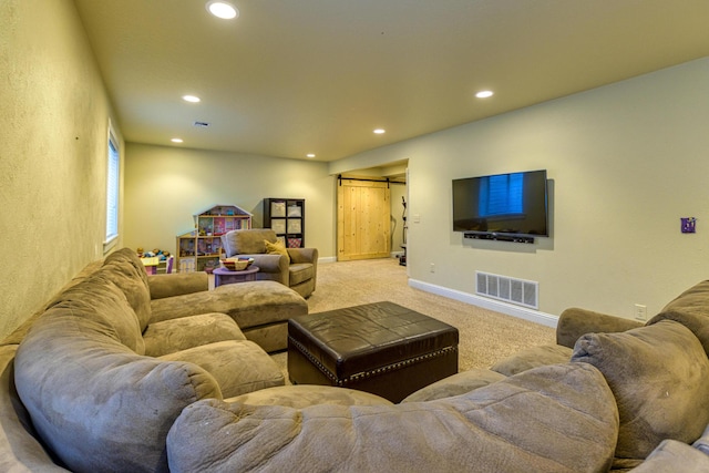 living room featuring light carpet and a barn door