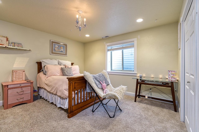 carpeted bedroom with a notable chandelier and a closet